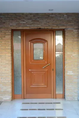 a brown door with a window on a brick building at The frescamento.collection apartment in Athens