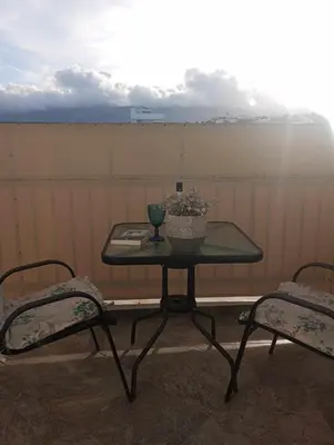 a table with a vase on it with two chairs at The frescamento.collection apartment in Athens
