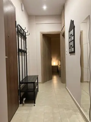 a hallway with a door and a table in a room at Bijou Kalamakiou (Athens Riviera) in Athens