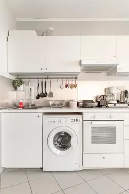 a white kitchen with a washing machine in it at Lovely APT w/heated Jacuzzi &full Acropolis view in Athens
