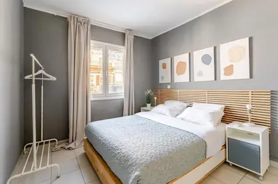 a bedroom with a large bed and a window at Lovely APT w/heated Jacuzzi &full Acropolis view in Athens