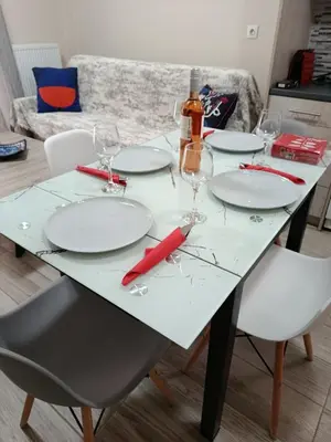 a table with empty plates and wine glasses on it at Alimos Apartments in Athens