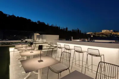 a group of chairs and tables on a roof at Neoma in Athens