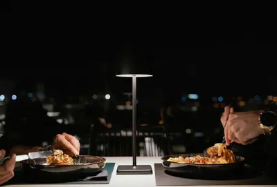 two people sitting at a table with plates of food at Neoma in Athens