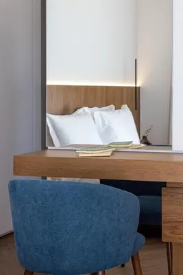 a desk with a blue chair and a mirror at Neoma in Athens