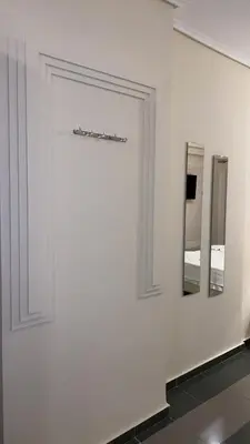 a white wall with two mirrors on it at Dina apartment in Athens