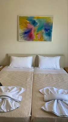 two beds sitting next to each other with towels on them at Athens apartment in Athens
