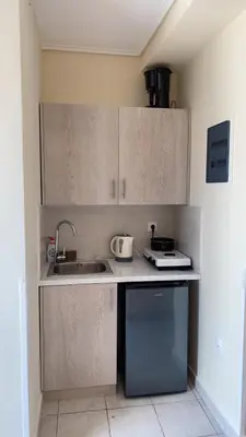 a small kitchen with a sink and a microwave at Athens apartment in Athens