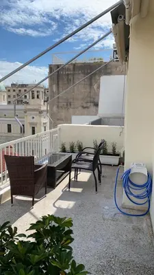 a balcony with two chairs and a bench on a balcony at Athens apartment in Athens