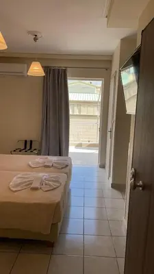 a bedroom with two beds and a large window at Athens apartment in Athens