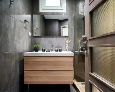 a bathroom with a sink and a mirror at New Apartment in the Heart of Plaka in Athens