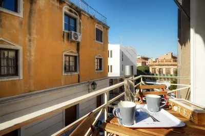 a balcony with a table with two coffee cups on it at New Apartment in the Heart of Plaka in Athens