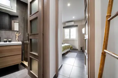 a bathroom with a sink and a bed in a room at New Apartment in the Heart of Plaka in Athens