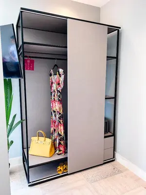 a wardrobe with a dress and a yellow purse at Royalty Suites Psyrri in Athens