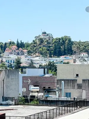 a view of a city with a building at Royalty Suites Psyrri in Athens