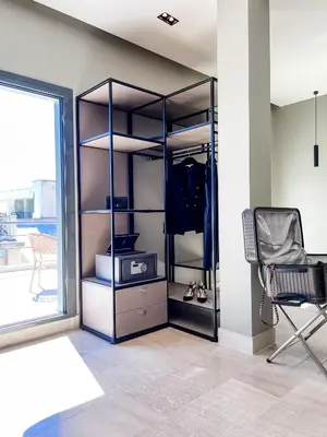 a room with a closet with a chair and a window at Royalty Suites Psyrri in Athens