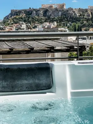 a bath tub with a view of a city at Royalty Suites Psyrri in Athens