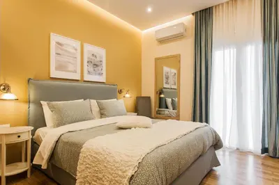 a bedroom with a bed and a large window at City stay Athens ''a Sweet Home''next to the metro in Athens