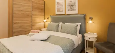 a bedroom with a large bed and a chair at City stay Athens ''a Sweet Home''next to the metro in Athens