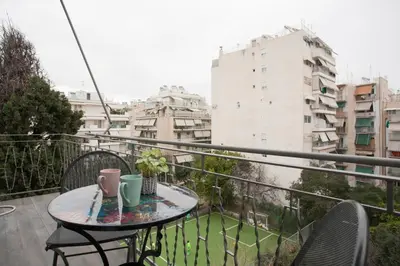a balcony with a table and chairs on a balcony at City stay Athens ''a Sweet Home''next to the metro in Athens