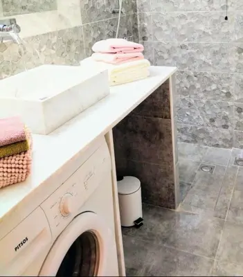 a washing machine under a counter in a bathroom at City stay Athens ''a Sweet Home''next to the metro in Athens