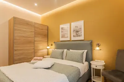 a small bedroom with a bed and a chair at City stay Athens ''a Sweet Home''next to the metro in Athens
