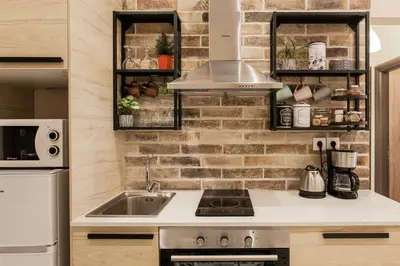a kitchen with a sink and a brick wall at City stay Athens ''a Sweet Home''next to the metro in Athens