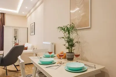 a living room with a table with plates and wine glasses at City stay Athens ''a Sweet Home''next to the metro in Athens