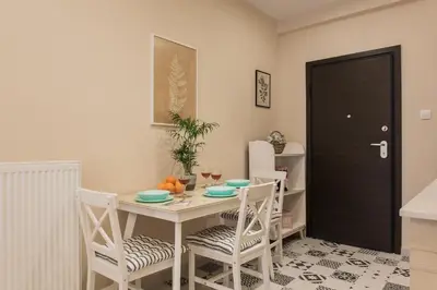 a dining room with a table and chairs and a black door at City stay Athens ''a Sweet Home''next to the metro in Athens