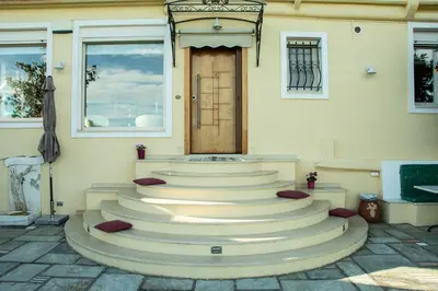 a set of stairs in front of a building with a door at Maya's home in Dhaskalión