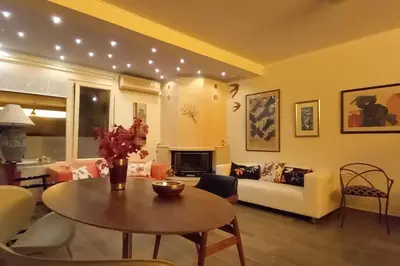 a living room with a table and a couch at Maya's home in Dhaskalión