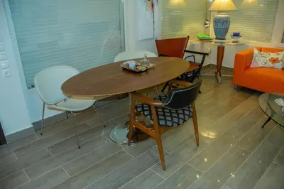 a living room with a wooden table and chairs at Maya's home in Dhaskalión