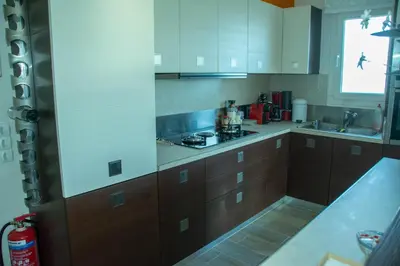 a kitchen with wooden cabinets and a stove top oven at Maya's home in Dhaskalión