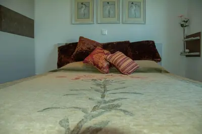 a bed with two pillows on top of it at Maya's home in Dhaskalión