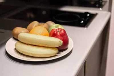 a plate of fruit on a kitchen counter at A11 Pristine & comfy studio near Plaka & Parthenon in Athens