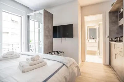 a bedroom with a bed with towels on it at A13 Pristine & Sunny 30m2 flat near Syntagma sq in Athens