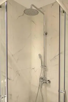a shower with a glass door in a bathroom at A13 Pristine & Sunny 30m2 flat near Syntagma sq in Athens