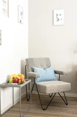 a chair and a table with a bowl of fruit at A13 Pristine & Sunny 30m2 flat near Syntagma sq in Athens