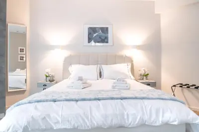 a bedroom with a white bed with towels on it at A16 Premium suite near Plaka in Athens center in Athens