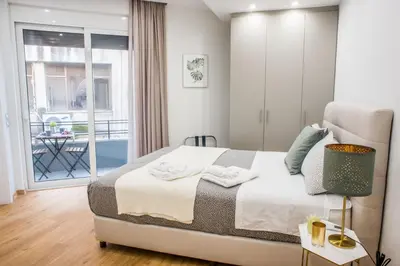 a small bedroom with a bed and a balcony at A24 Pristine & sunny suite near Plaka & Parthenon in Athens