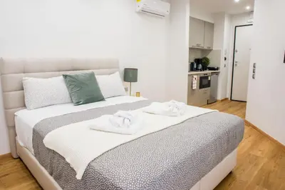 a bedroom with a large white bed with towels on it at A24 Pristine & sunny suite near Plaka & Parthenon in Athens