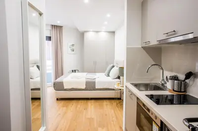 a small kitchen with a bed in a room at A24 Pristine & sunny suite near Plaka & Parthenon in Athens