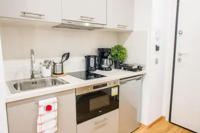 a kitchen with a sink and a stove top oven at A24 Pristine & sunny suite near Plaka & Parthenon in Athens