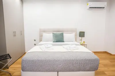 a bedroom with a large bed with two towels on it at A24 Pristine & sunny suite near Plaka & Parthenon in Athens