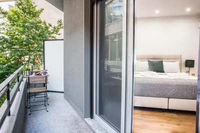 a balcony with a bed and a window at A24 Pristine & sunny suite near Plaka & Parthenon in Athens