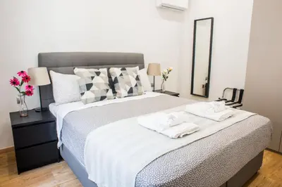 a bedroom with a large bed with two towels on it at A22 Premium flat with balcony in the centre in Athens