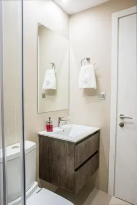 a bathroom with a sink and a toilet and a mirror at A22 Premium flat with balcony in the centre in Athens