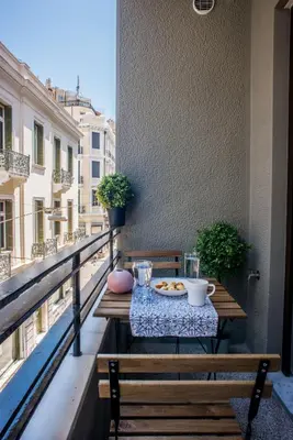 a table on a balcony with a plate of food at A22 Premium flat with balcony in the centre in Athens
