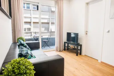 a living room with a couch and a tv at A22 Premium flat with balcony in the centre in Athens