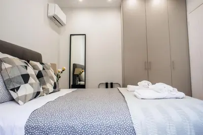 a bedroom with a large bed with towels on it at A22 Premium flat with balcony in the centre in Athens